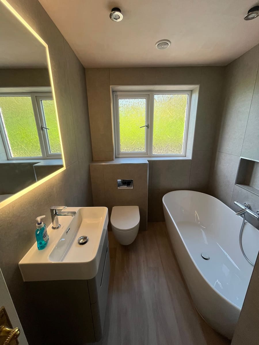 Completed BOILR+ bathroom with a freestanding bath and natural light