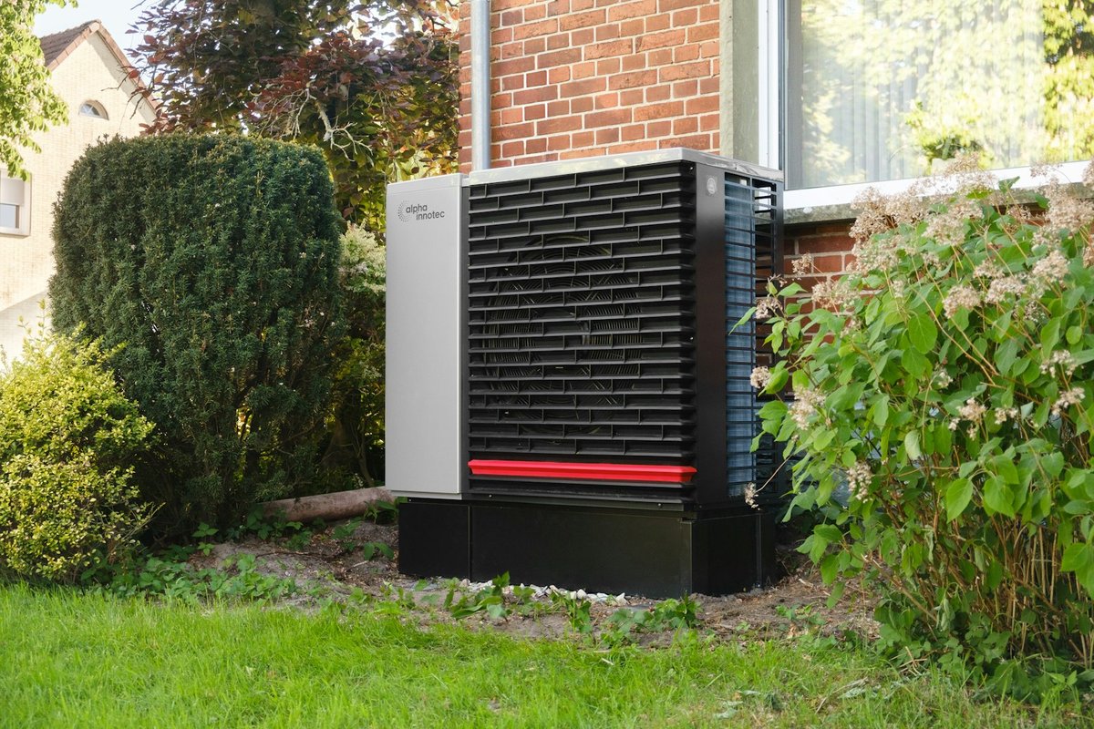 Air source heat pump installed outside a brick home